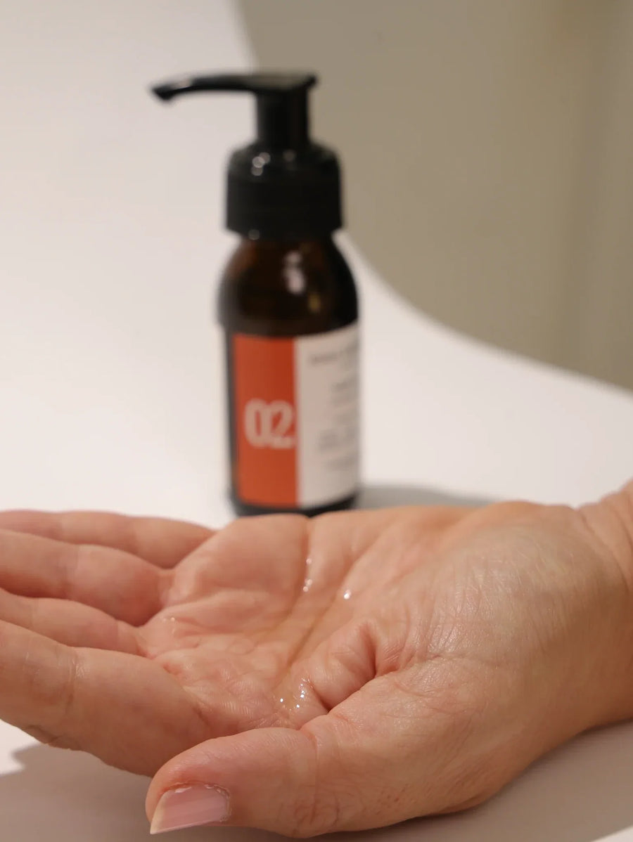 No 02 Pre-Wash Hair Oil poured into the palm